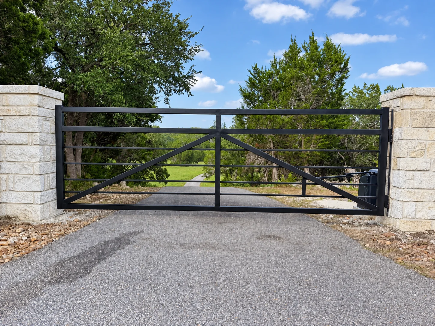 Custom gate between limestone pillars
